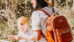 Itzy Ritzy Mini Diaper Bag Backpack & Chic Mini Diaper Bag Backpack with Vegan Leather Changing Pad, 8 Total Pockets (4 Internal and 4 External), Grab-Top Handle and Rubber Feet, Cognac